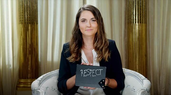 woman holding a card with word 'respect'
