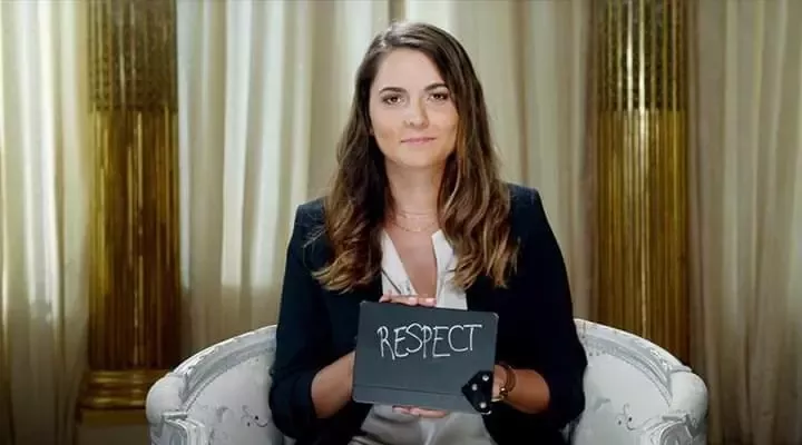 woman holding a card with word 'respect'