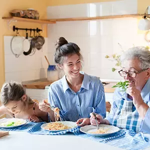 Family sharing a meal together at home around a kitchen table