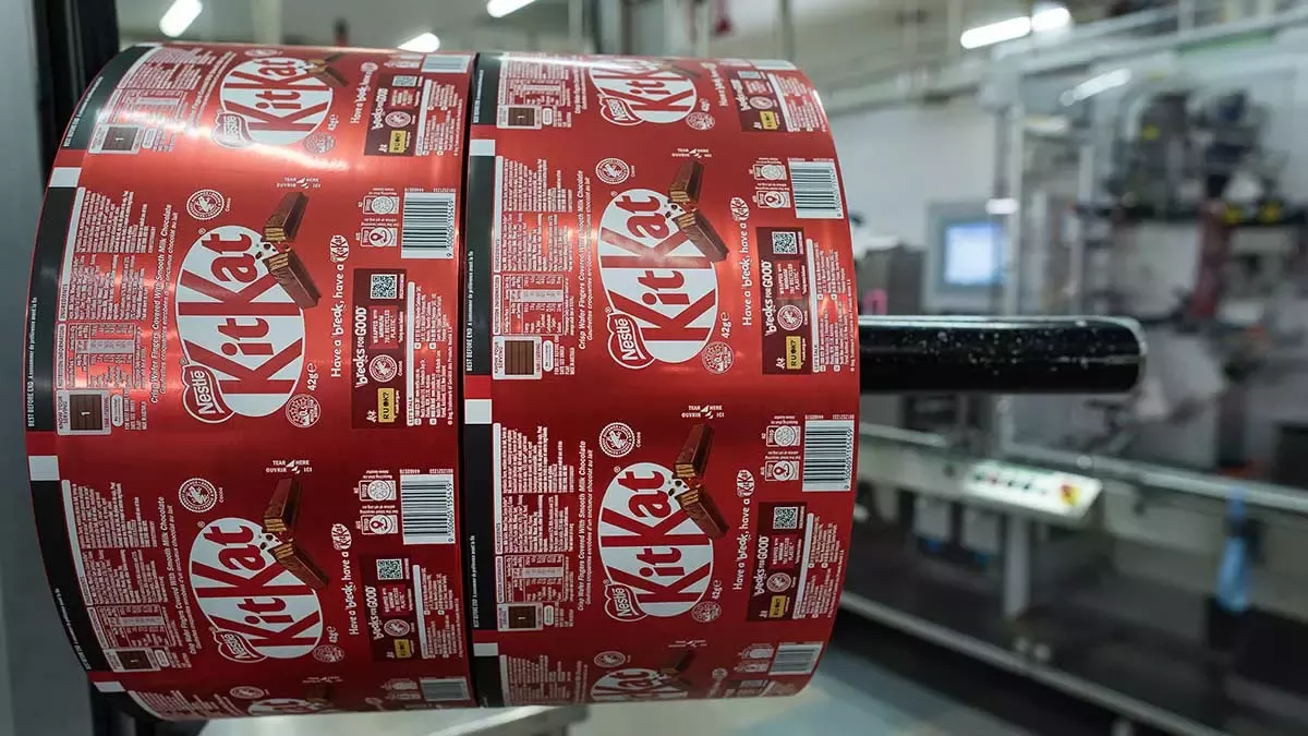 KitKat packaging roll on a production line in a modern food manufacturing facility